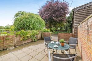 a patio with a table and chairs and a fence at 2 Bed in Denton oc-b42753 in Kenton