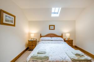 a bedroom with a large bed with two night stands at 2 Bed in Denton oc-b42753 in Kenton