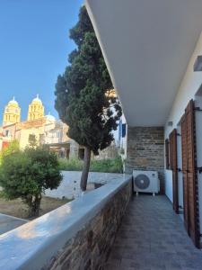 a walkway leading to a building with a tree at Flaburiotis House in Dhriopís