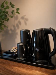 two black coffee cups sitting on a tray at Pensjonat Kocius in Rewal +13 photos