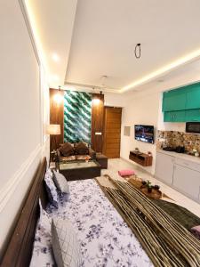 a large living room with a couch and a kitchen at Darshana Studios# Couple Friendly in Noida