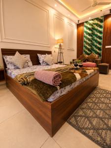 a large wooden bed in a room with at Darshana Studios# Couple Friendly in Noida