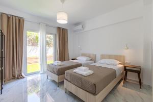a hotel room with two beds and a window at Casa Eda in Agia Marina Nea Kydonias +48 photos