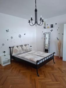a bedroom with a bed and a chandelier at Ferienhaus Savannah in Schützen am Gebirge