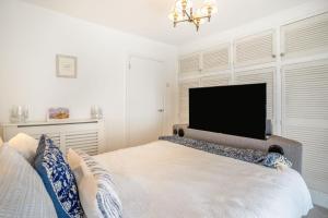 a bedroom with a large bed with a flat screen tv at 2 Bed in Mumbles oc-t42823 in The Mumbles