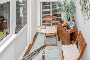 a balcony with two chairs and a desk and a window at 2 Bed in Mumbles oc-t42823 in The Mumbles