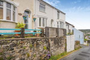 a stone retaining wall in front of a house at 2 Bed in Mumbles oc-t42823 in The Mumbles