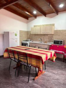 a kitchen with a table with a red and yellow at Dos Osos in Villa General Belgrano