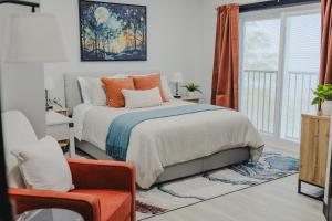 a bedroom with a bed and a window at Falkenberg Business Centre and Suites in Botwood