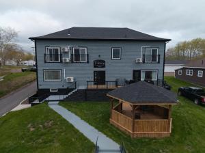 a house with a gazebo in front of it at Falkenberg Business Centre and Suites in Botwood