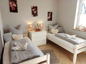 a bedroom with two beds and a table with candles at Eifel Dream Wildeiche in Fleringen