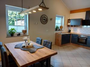 a kitchen and dining room with a wooden table at Eifel Dream Wildeiche in Fleringen