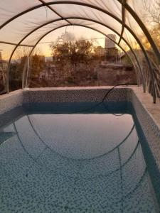 a pool of water in a building with an umbrella at Mateo y Stella in Bialet Massé +5 photos