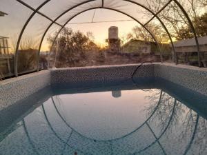 an empty swimming pool with a metal fence around it at Mateo y Stella in Bialet Massé