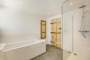 a white bathroom with a tub and a shower at 1 Bed in Barrow oc-b42641 in Barrow