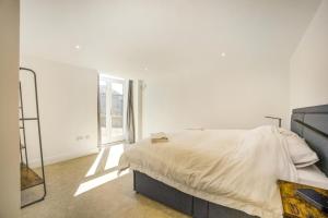 a white bedroom with a bed and a window at 1 Bed in Barrow oc-b42641 in Barrow