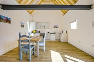 a kitchen and dining room with a table and chairs at 1 Bed in Barrow oc-b42641 in Barrow +11 photos