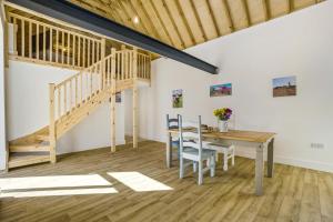 a dining room with a wooden table and a staircase at 1 Bed in Barrow oc-b42641 in Barrow