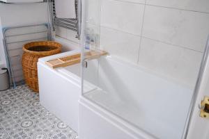 a white bathroom with a glass shower backdoor at Stoops Hall - 2 bed first floor apartment in Garstang +12 photos