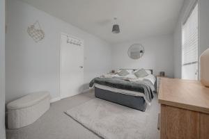 a bedroom with a bed and a toilet and a desk at Stoops Hall - 2 bed first floor apartment in Garstang