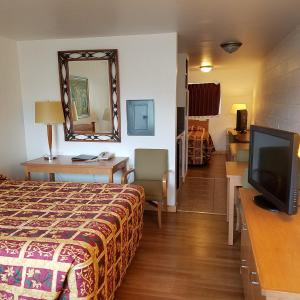 a hotel room with a bed and a television at San Juan Motel in Anacortes