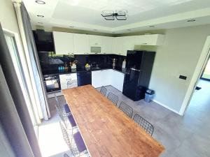 an aerial view of a kitchen with a wooden table and chairs at VillaZ Villa Ardeşen in Ardeşen