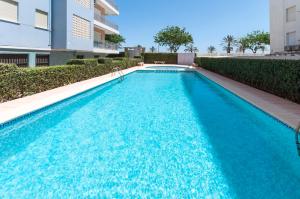 a swimming pool in front of a building at AG LAS SIRENAS in Playa de Gandia