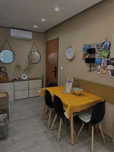 a dining room with a wooden table and chairs at Qerret Boutique Studio Apartment in Golem +25 photos