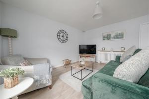 a living room with a couch and a table at Stoops Hall - 2 bed first floor apartment in Garstang