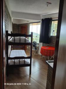 a living room with two bunk beds and a table at Studio na Serra I in Itatiaia +46 photos
