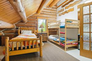 a bedroom with two bunk beds in a log cabin at Viewtopia in Suttons Bay