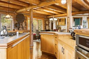a kitchen with wooden cabinets and a large kitchen island at Viewtopia in Suttons Bay