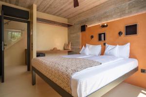 a bedroom with a large bed with white sheets at Turtle Home in Skala +30 photos