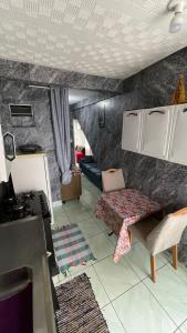 a kitchen and living room with a couch and a table at Kitnet aconchegante in Ouro Preto +27 photos