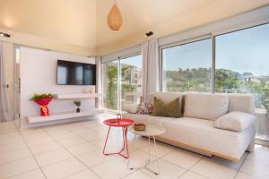 a living room with a couch and large windows at Turtle Home in Skala