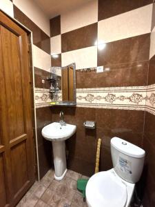 a bathroom with a toilet and a sink at Matevosyans Guest House in Goris +9 photos