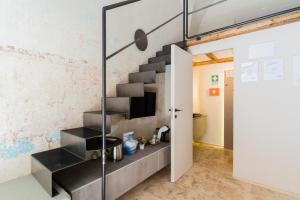 a metal staircase in a room with a sliding glass door at Luxury Rooms in Alezio