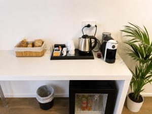 a table with a coffee maker and a coffee pot on it at Astra - Exclusive Rooms in Castelsardo