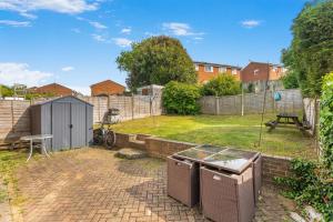 a backyard with a fence and a picnic table at Badger Haven, Apartment 3 in Brackley