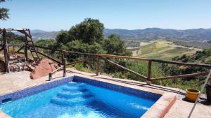 a swimming pool with a view of a mountain at Casa KiSi Hotel, Rural Boutique Bed & Breakfast in Colmenar