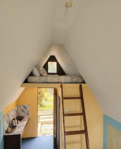 a room with two bunk beds and a ladder at Sabda Desa Cabin in Cinyiruan +9 photos