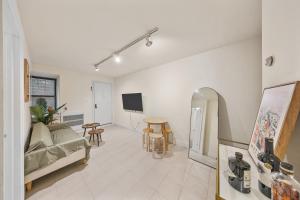 a living room with a couch and a table at Chic One Bedroom Retreat in Downtown Manhattan in New York