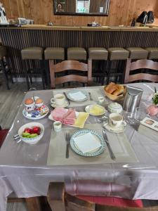 a table with plates and bowls of food on it at Erve Ther Maet in Weerselo