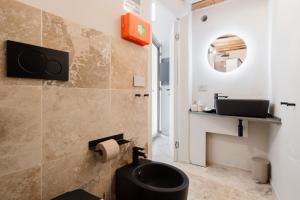 a bathroom with a black toilet and a sink at Luxury Rooms in Alezio +44 photos
