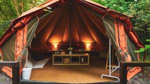 a large tent with a table in the middle at River Tribe Glamping in Laino Borgo