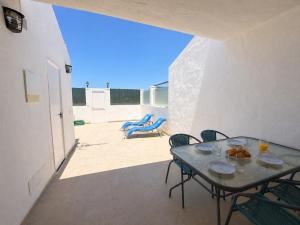 a patio with a table and chairs on a balcony at Sunny Bungalow with Pool & Patio in Sonnenland By Canarias Prime Homes in Maspalomas