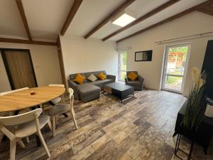 a living room with a table and a couch at Ranč v Landu in Kamýk nad Vltavou