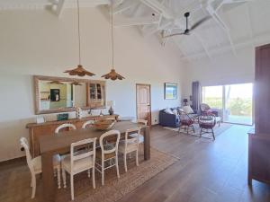 a kitchen and dining room with a table and chairs at Villa JAUNE in Oyster Pond