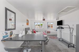 a living room with a table and a living room at Badger Haven, Apartment 4 in Brackley