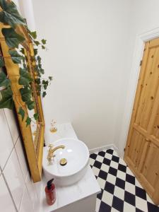 a bathroom with a white sink and a mirror at Exclusive Luxury Apartment with free private parki in Aalborg